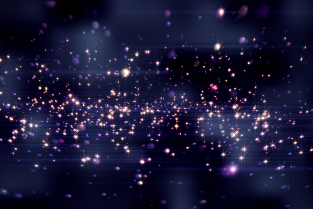 Purple bright glittering light circles on dark background